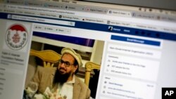 FILE - A photo shows a Facebook site that features Hafiz Saeed, founder of Lashkar-e-Taiba, a banned organization and a U.S.-declared terrorist group, in Islamabad, Pakistan, July 7, 2017. A senior Pakistani government official said at the time that more than 40 of 65 organizations banned in Pakistan operated flourishing social media sites.