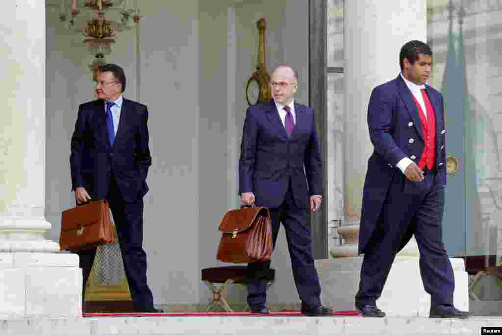 French Interior Minister Bernard Cazeneuve (center) leaves after a war cabinet meeting at the Elysee Palace in Paris, Sept. 25, 2014. 
