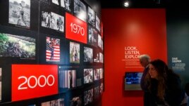 People visit the Pulitzer Prize Photography exhibition at the Newseum, Friday, Dec. 20, 2019, in Washington. (AP Photo/Jacquelyn Martin)