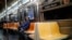 A commuter wears a face mask while riding the a nearly empty subway car into Brooklyn, in New York, March 12, 2020.