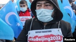 FILE - People from China's Uyghur Muslim ethnic group protest outside the city's Turkish Olympic Committee building, calling for a boycott of the Winter Olympics in Beijing over China's treatment of the minority, in Istanbul, Turkey, Jan. 23, 2022. 