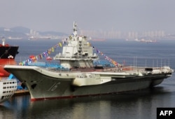 This photo taken on September 24, 2012, shows China's first aircraft carrier, a former Soviet carrier, docked after its handover to the PLA Navy in Dalian, in northeast China's Liaoning province.