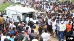 Indian state government workers from 'free hearse service' transport a body on their vehicle after a blast at a fireworks factory in Warangal, in the south Indian state of Telangana, July 4, 2018.