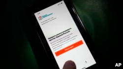 The Russian opposition-created Smart Voting app is seen displayed on a mobile phone screen in Moscow, Russia, Sept. 17, 2021. The app disappeared from the Telegram messenger following its removal by Apple and Google Friday as parliamentary elections went 