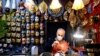 A mask artisan works inside his shop during what would have been Venice's annual colorful carnival, but was canceled this year due to the COVID-19 pandemic, in Venice, Italy, Feb. 7, 2021.