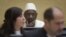 Congolese warlord Thomas Lubanga, center, awaits his verdict in the courtroom of the International Criminal Court (ICC) in The Hague, Netherlands, March 14, 2012. 