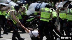 FILE - A demonstrator is arrested by riot police while rallying against Venezuela's President Nicolas Maduro's government in Caracas, Venezuela April 10, 2017. 