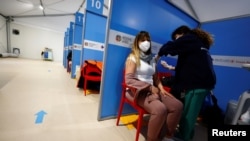 A medical worker injects the AstraZeneca coronavirus vaccine at Fiumicino Airport in Rome, Italy, March 8, 2021.