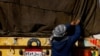 An Egyptian truck driver resecures cargo on an aid truck after inspection, before entering Gaza, amid the ongoing conflict between Israel and the Palestinian Islamist group Hamas, at the Kerem Shalom crossing, in Israel, December 22, 2023.