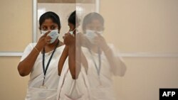 FILE - Nurses speak inside a newly created mpox isolation ward at a hospital in Chennai, India, Aug. 27, 2024.