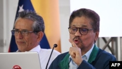 ARCHIVO: Iván Márquez lee en voz alta junto a Walter Mendoza, ambos representantes del grupo armado Segunda Marquetalia, el lunes 24 de junio de 2024, durante el inicio de conversaciones de paz con el gobierno colombiano, en Caracas, Venezuela.