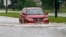 A driver attempts to steer through the remaining floodwaters from Harvey on Legion Street in Lake Charles, La., Aug. 29, 2017. 