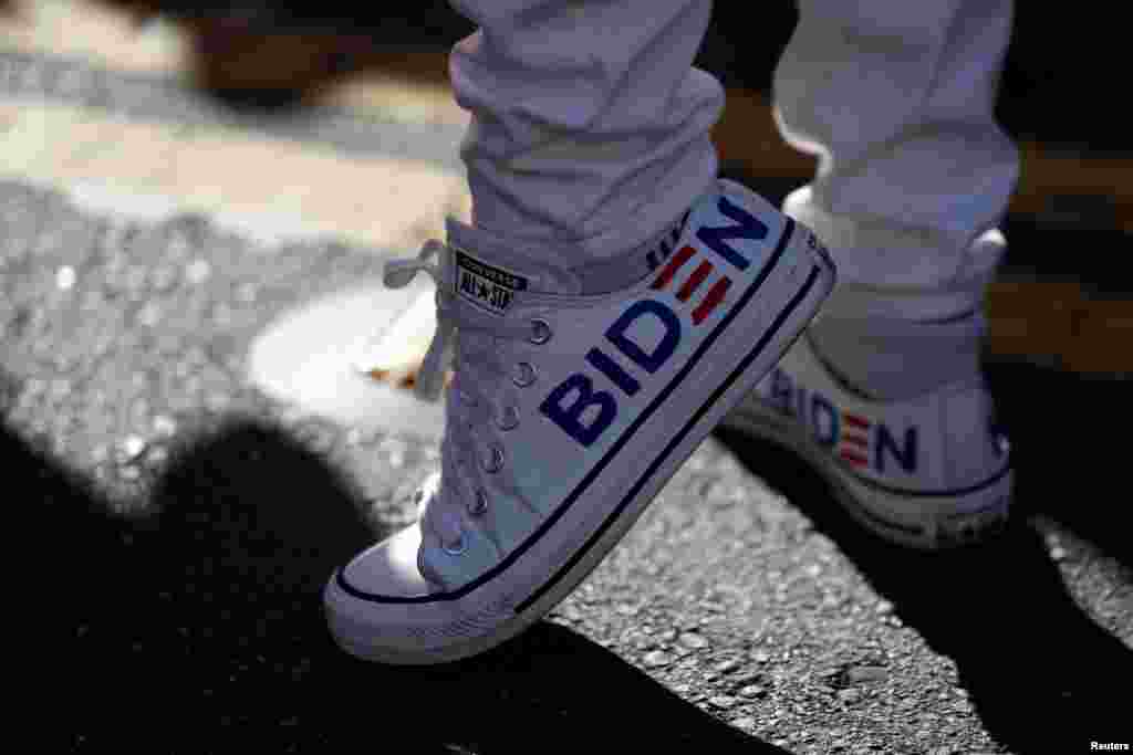 A supporter wearing sneakers with Biden&#39;s name is seen as people celebrate in the Castro district after news media declared U.S. presidential nominee Joe Biden the winner of the 2020 election.