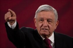 FILE - Mexico's President Andres Manuel Lopez Obrador gives his daily, morning news conference at the presidential palace, Palacio Nacional, in Mexico City, July 13, 2020.