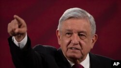 FILE - Mexico's President Andres Manuel Lopez Obrador gives his daily, morning news conference at the presidential palace, Palacio Nacional, in Mexico City, July 13, 2020.