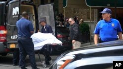 The body of designer Kate Spade is removed from her apartment building in New York on June 5, 2018. 