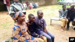 Parents are reunited with released students of the Bethel Baptist High School in Damishi, Nigeria, July 25, 2021. Armed kidnappers in Nigeria have released 28 of the more than 120 students who were abducted at the beginning of July.