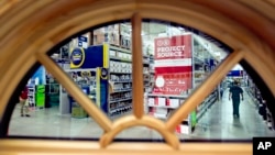 FILE - A shopper is seen through a window on display at a Lowe's store in Atlanta. The U.S. economy grew at the fastest pace in two years in Q3 2016, driven by businesses making purchases to restock shelves and rising exports.