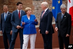 G-7 leaders, from left, President of the European Commission Jean-Claude Junker, Canadian Prime Minister Justin Trudeau, German Chancellor Angela Merkel, President Donald Trump, and Italian Prime Minister Paolo Gentiloni, pose for a family photo at the Anc