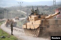 A Turkish military convoy arrives at a village on the Turkish-Syrian border in Kilis province, Turkey, Jan. 21, 2018.