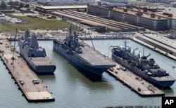 The amphibious assault ship USS Wasp (center) sits pierside along with support ships at Naval Station Norfolk in Norfolk, Va., April 27, 2016.