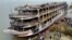 সুগন্ধা নদীর তীরে রাখা হয়েছে ঝালকাঠিতে আগুন লাগা লঞ্চটি। আগুনে কয়েক ডজন মানুষ মারা যান। (ছবি- রয়টার্স) 