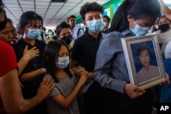 Family members of Khant Ngar Hein grieve during his funeral in Yangon, Myanmar, March 16, 2021. Khant Ngar Hein, a 18-year-old student of medicine was shot on his chest on March 14, in Tamwe, Yangon, by security forces.