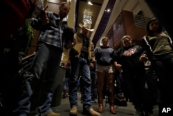 Mourners pray during a vigil to remember victims of a mass shooting in Thousand Oaks, California, Nov. 8, 2018.