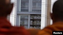 Buddhist monks gather at a memorial stupa with bones of more than 8,000 victims of the Khmer Rouge regime at Choeung Ek, a "Killing Fields" site located on the outskirts of Phnom Penh, file photo. 