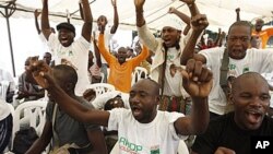 Supporters of opposition leader Alassane Ouattara, make their feelings known, as they sing at an event at a hotel in Abidjan, Ivory Coast, 30 Dec 2010