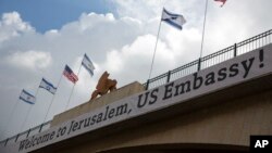 A sign on a bridge leading to the U.S. Embassy compound ahead the official opening in Jerusalem, May 13, 2018. 