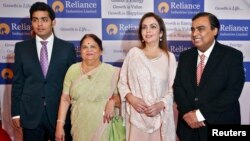 FILE - Mukesh Ambani (R), chairman of Reliance Industries Ltd, poses with his wife Nita (2nd R), mother Kokilaben (2nd L) and son Akash, before addressing the company's annual shareholders' meeting in Mumbai.