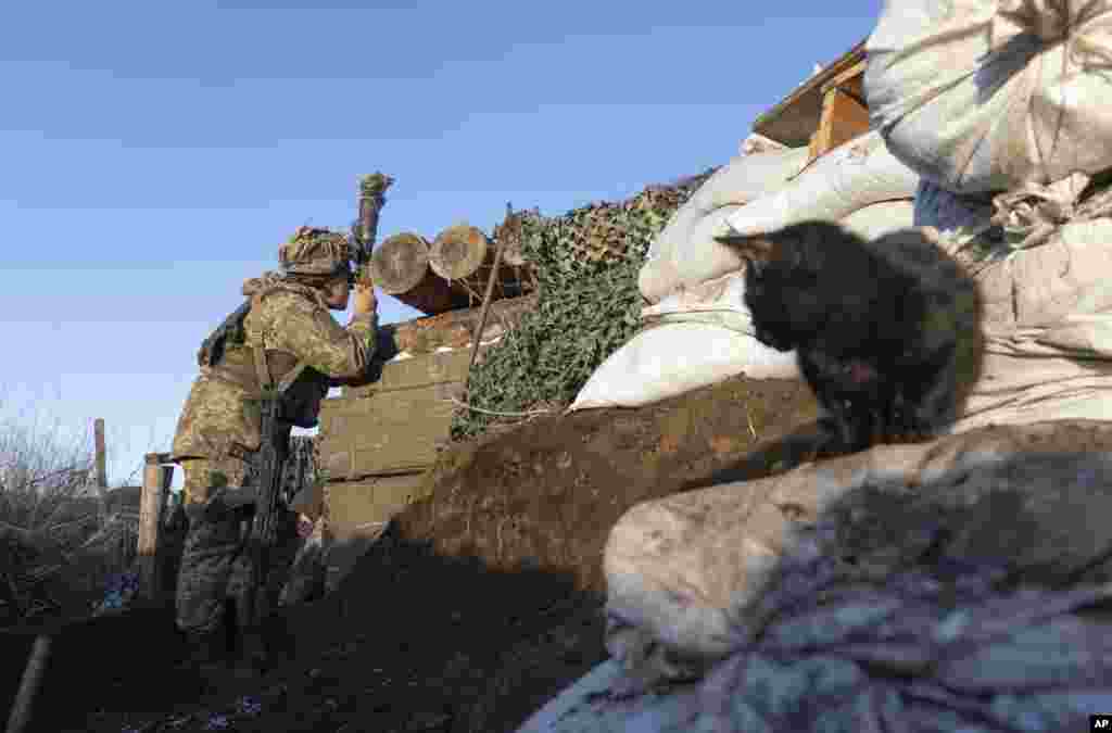 A Ukrainian soldier is seen in a trench at the line of separation from pro-Russian rebels, Donetsk region, Ukraine, Jan. 8, 2022.