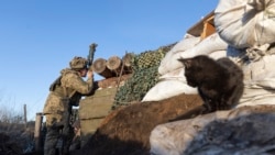 A Ukrainian soldier in a trench at the line of separation from pro-Russian rebels, Donetsk region, Ukraine, Saturday, Jan. 8, 2022.