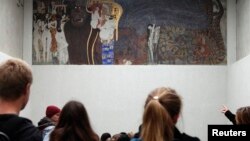 Visitors look at Gustav Klimt's Beethoven Frieze, one of the country's most famous artworks, at the Secession museum in Vienna, Oct. 16, 2013. 