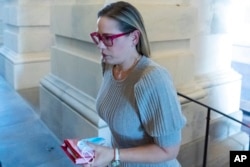 FILE - Sen. Kyrsten Sinema, D-Ariz., arrives for a vote on Capitol Hill, Nov. 1, 2021.