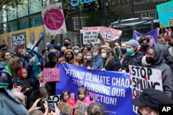 FILE - Climate activist Greta Thunberg, center, demonstrates with others in front of the Standard and Chartered Bank during a climate protest in London, England, Oct. 29, 2021. AP Photo/Frank Augstein, File)