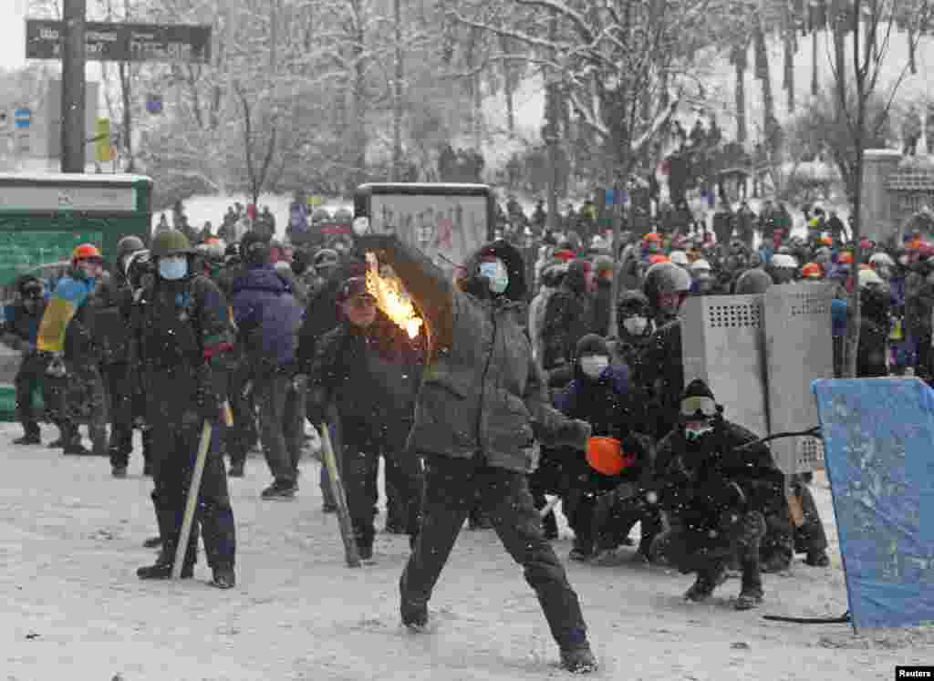A pro-European protester throws a Molotov cocktail during clashes with police in Kyiv, Jan. 22, 2014.