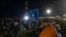 FILE - Migrants and refugees gather at a border crossing between Serbia and Hungary in Kelebija, Serbia, Feb. 6, 2020. 
