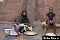 A displaced Malian woman gets ready to prepare a meal in their new home in Bamako, capital of the country. (UNHCR/H.Caux)