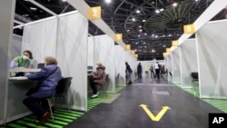 People get their COVID-19 vaccines at a new vaccination center at the Velodrom in Berlin, Germany, Feb. 17, 2021. 