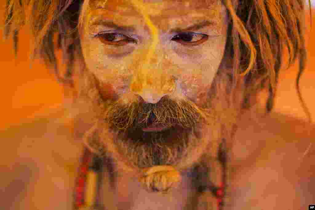 A Naga sadhu, or naked Hindu holy man, pauses inside a tent during Kumbh Mela, or Pitcher festival, at Trimbakeshwar, India.