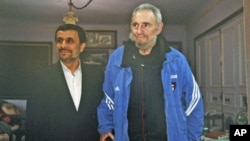 Iran's President Mahmoud Ahmadinejad (L) stands with former Cuban leader Fidel Castro, in Cuba, January 12, 2012.
