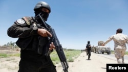 Members of the Iraqi security forces take their positions during an intensive security deployment west of Baghdad, Iraq, June 24, 2014. 