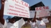 FILE: Members of the Zimbabwe Congress of Trade Unions hold banners advocating the scrapping of taxes on pension benefits in Harare, Sunday, May, 1, 2005, to celebrate International Workers Day.(AP Photo)