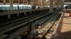 FILE - Workers transport building materials at the construction site of Halim Station ahead of a test run of the Jakarta-Bandung high-speed train, in Jakarta, Indonesia, Aug. 12, 2023. The first high-speed rail service in Southeast Asia is part of China's Belt and Road Initiative