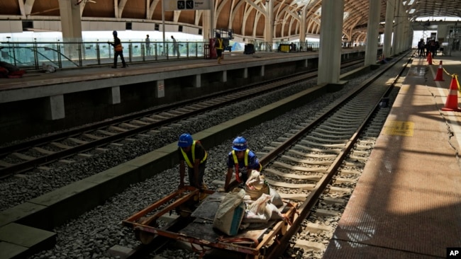 Workers transport building materials at the construction site of Halim Station ahead of a test run of the Jakarta-Bandung high-speed train, in Jakarta, Indonesia, Aug. 12, 2023. The first high-speed rail service in Southeast Asia is part of China's Belt and Road Initiative