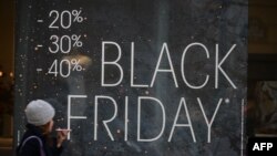 Pešak hoda pored izloga za vreme Black friday vikenda 