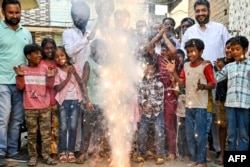 People burn firecrackers during celebrations on the eve of Diwali, the Hindu festival of lights, in Amritsar, India, on Oct. 30, 2024.