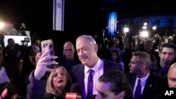 Blue and White party leader Benny Gantz arrives after exit polls for the Israeli elections at party's headquarters in Tel Aviv, Israel, Monday, March 2, 2020. (AP Photo/Sebastian Scheiner)